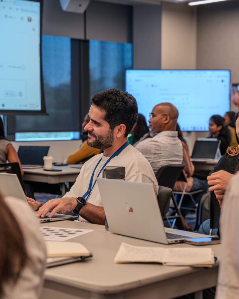 A training session with participants from several countries working on laptops.