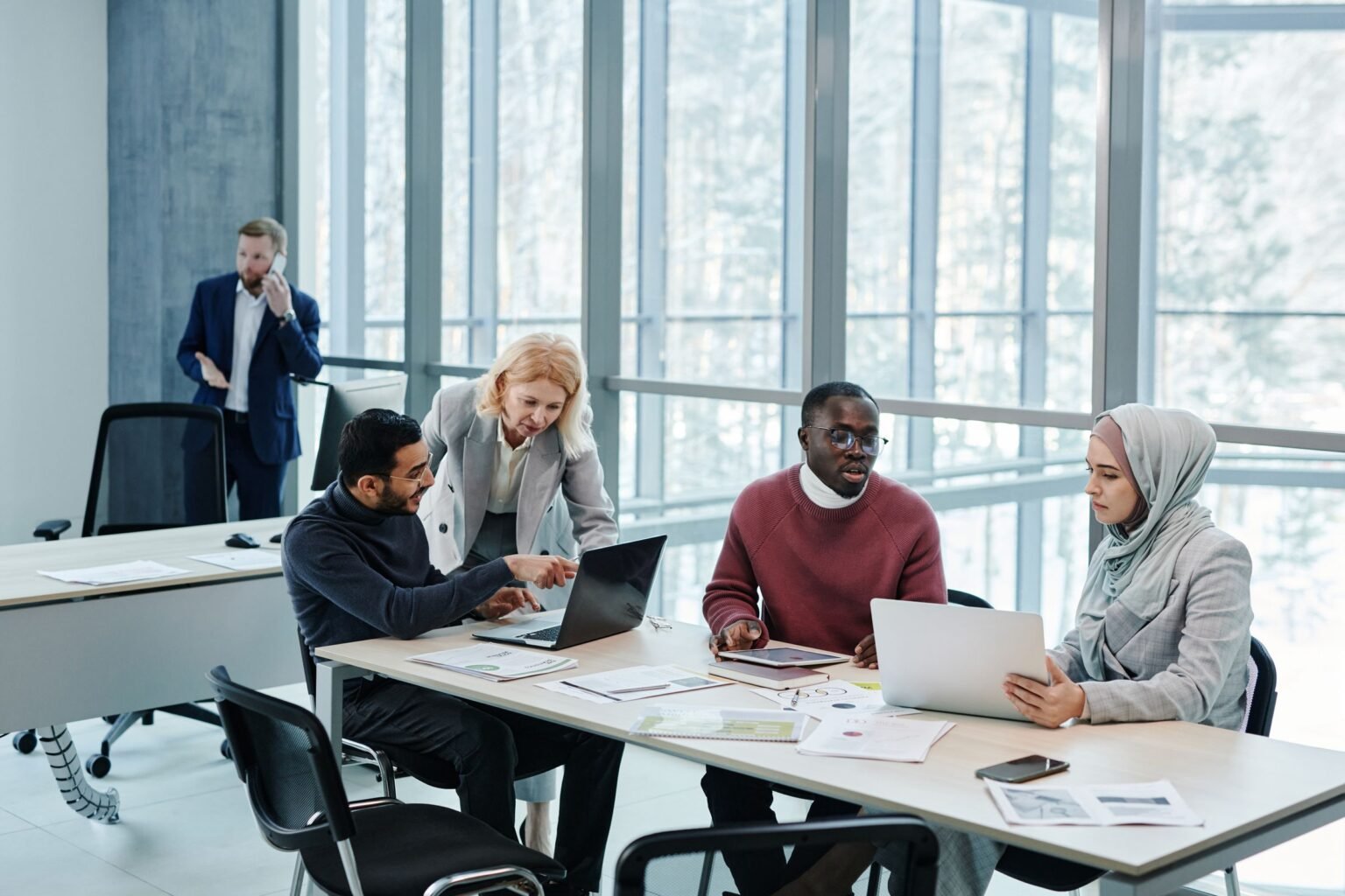 Colleagues from several countries working through a project around a meeting table.