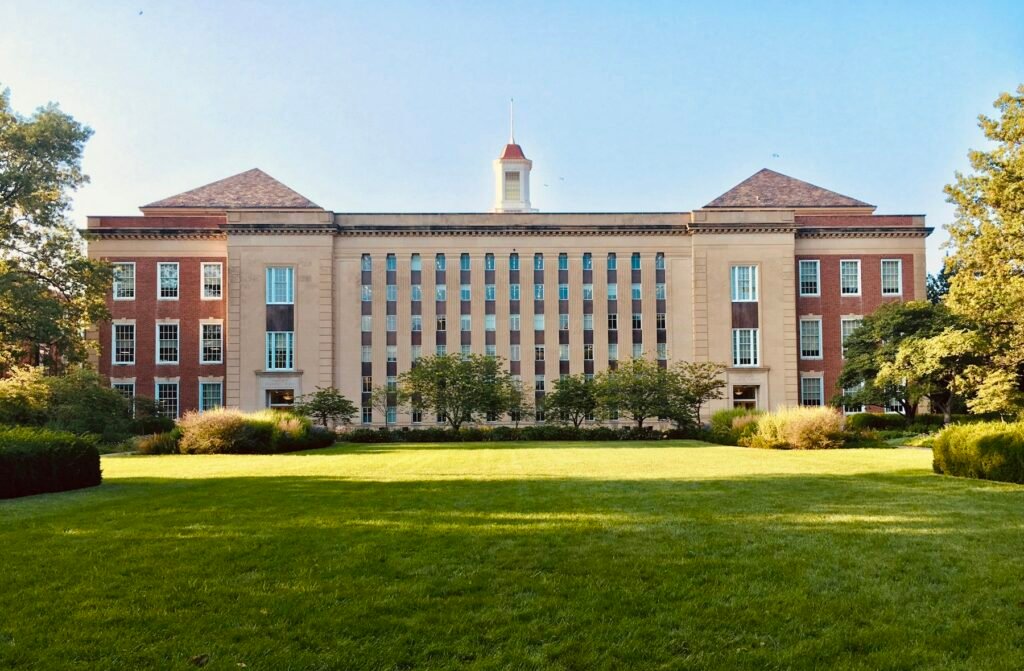A university building with open lawns in front of it.