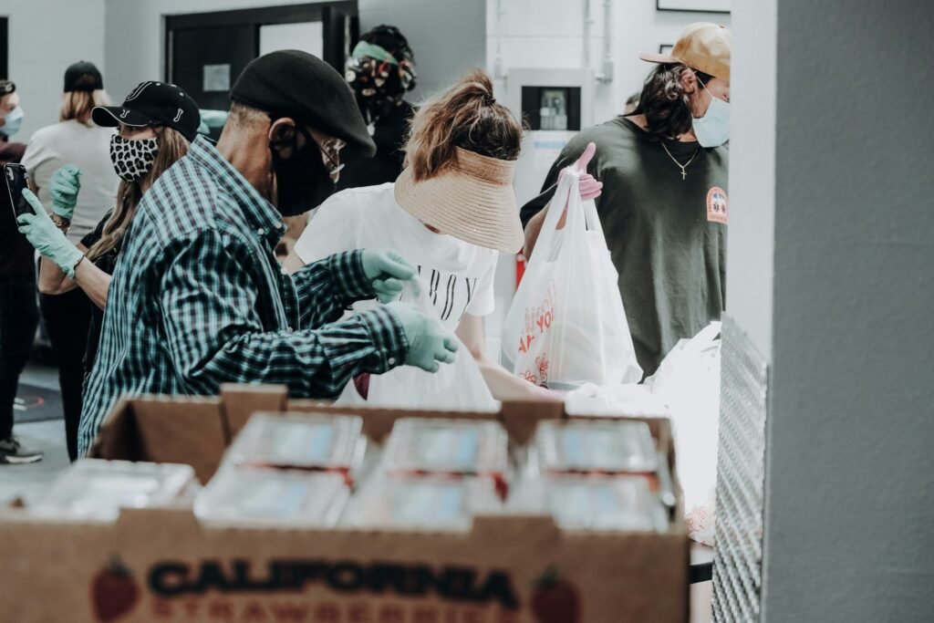 Volunteers packing supply boxes at a community distribution point.